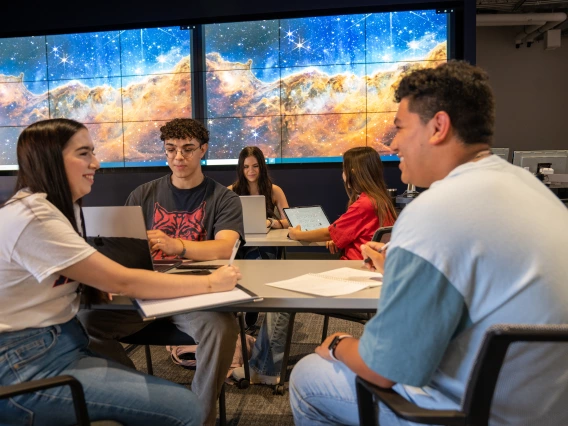 students talking around a table