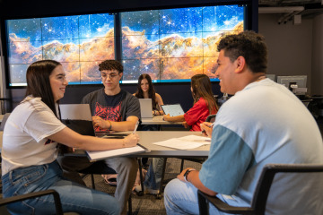 students talking around a table